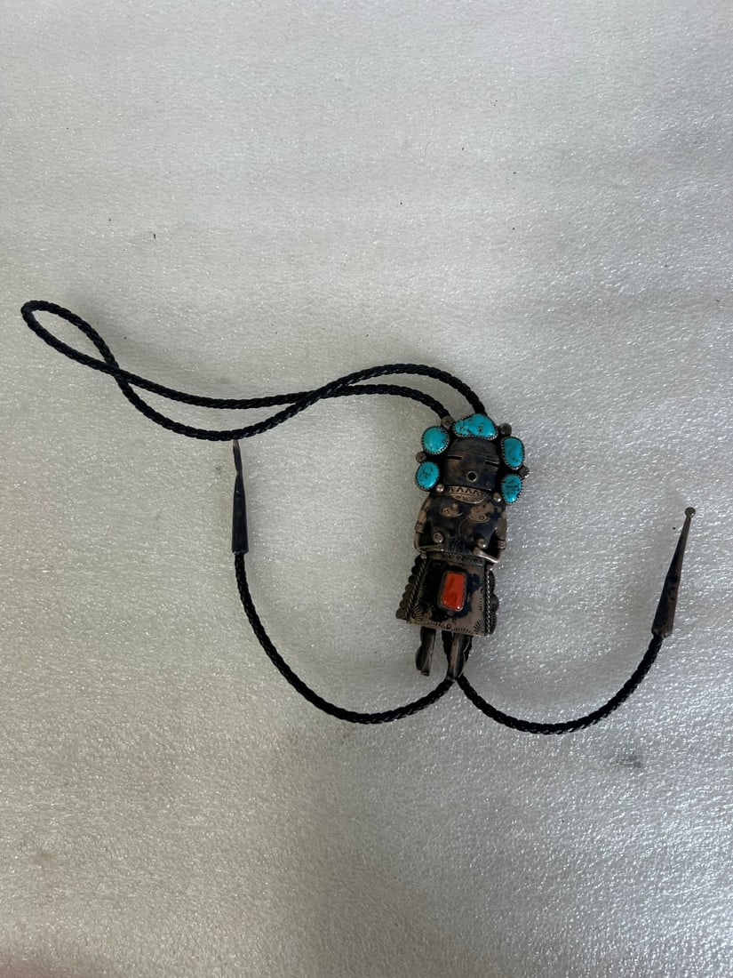 Sterling Silver Am. Indian Bolo: Sterling Figure with turquoise stones (5) comprising a head piece and a coral stone on the bottom "skirt" Marked Sterling 4 1/2"H