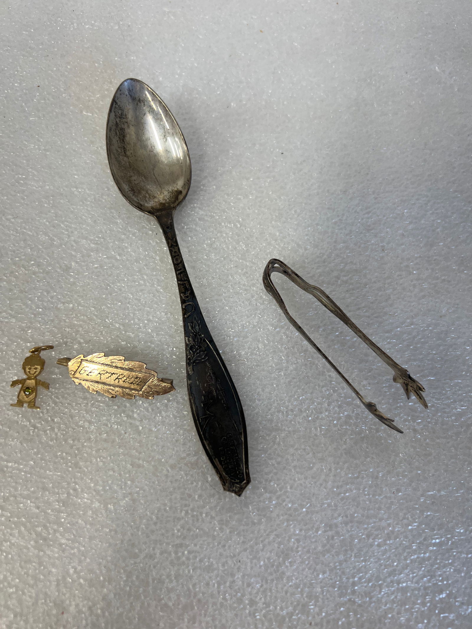 14K Gold (2) and Sterling (2) Lor. Four Items: Amina 14K Gold Pendant, a figure marked Amina and 14K at the back and a name pendant, marked Gertrude at the front and 14K Front at the back. Included in this lot is a sterling silver cube tong and a