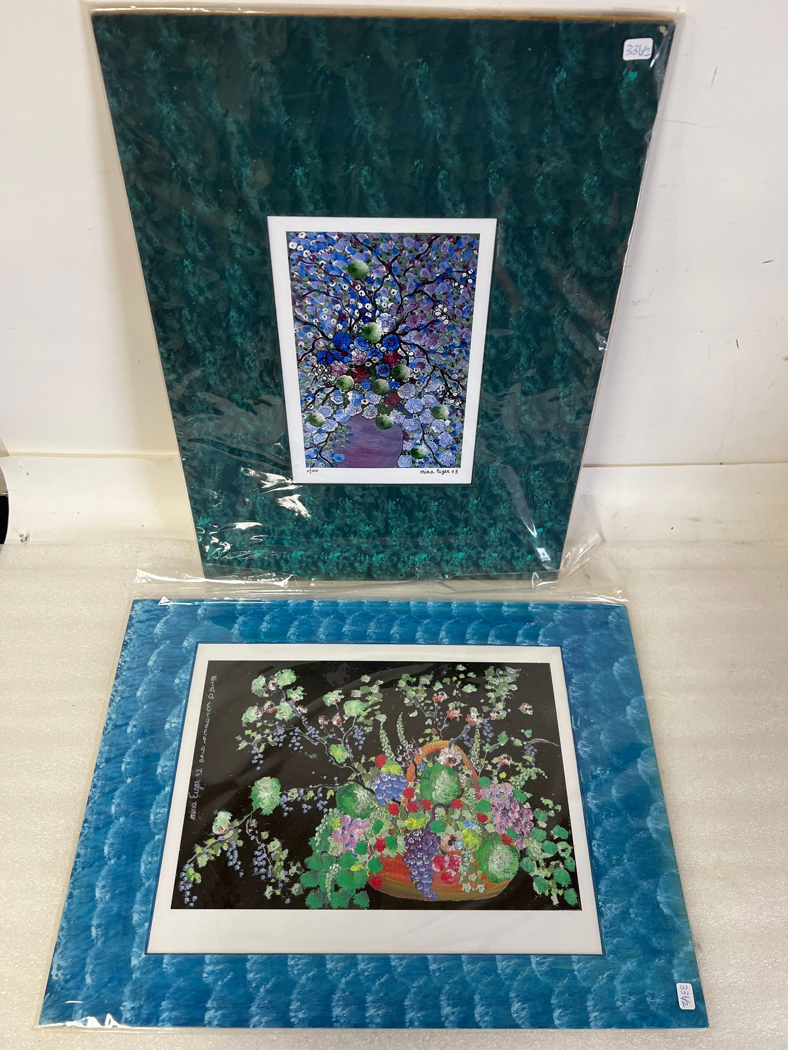 Mina Eiger Lithographs Sgd (2): Flowers on a black background Sgd 21 3/4” H by 15 3/4” W certificate at the reverse. Litho 11/100 Sgd matted 21 1/2” H by 16” W overall