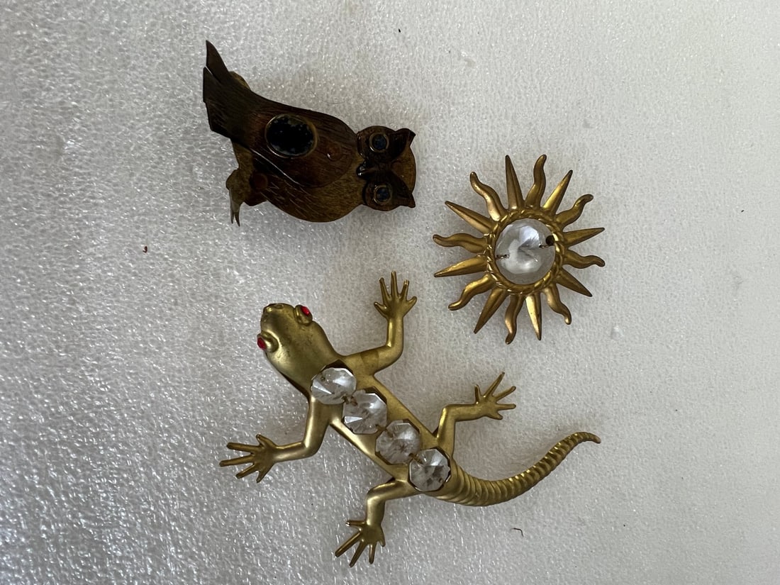 Antique Brass and Other Figures: A lizard with "ruby " eyes and crystal body segements; an owl with lapis eys and body stone, a sun with crystal. 5" to 2 1/2:"