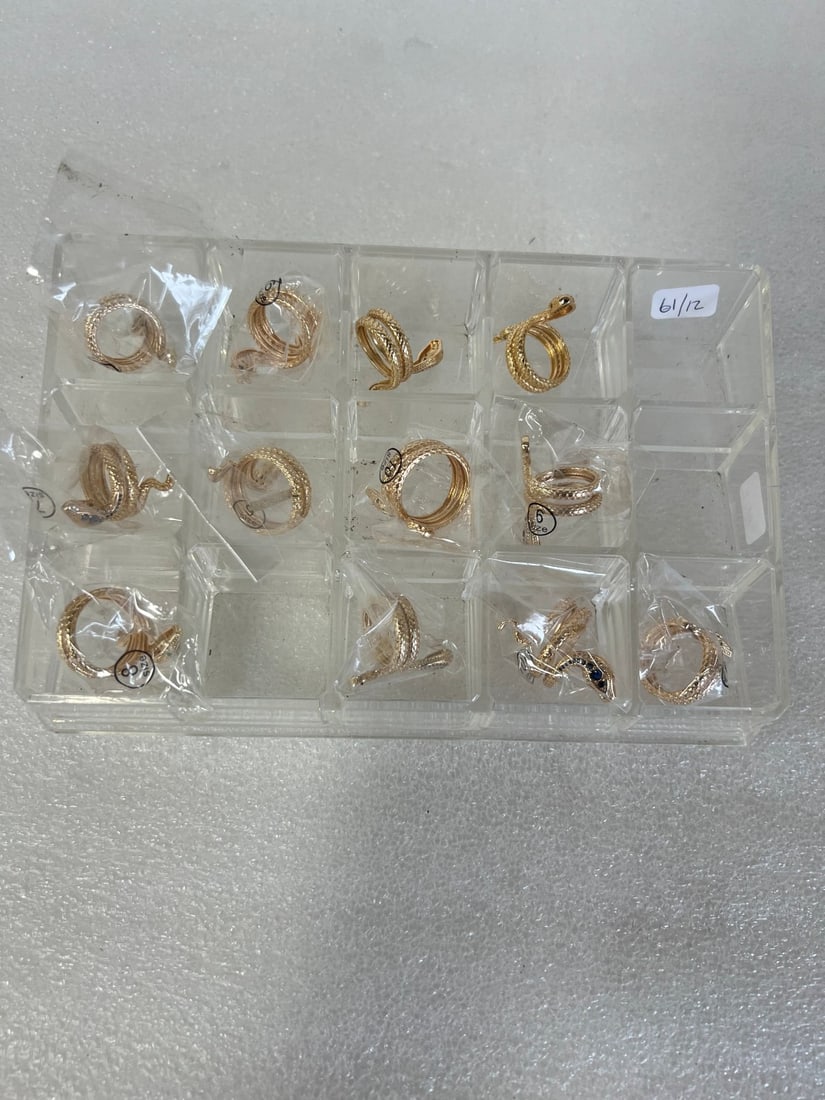 Twelve Snake Rings. "Sapphire" Eyes: Twelve gold filled well detailed coiled snake rings, all with blue "sapphire" eyes. Sizes 6 to 10.