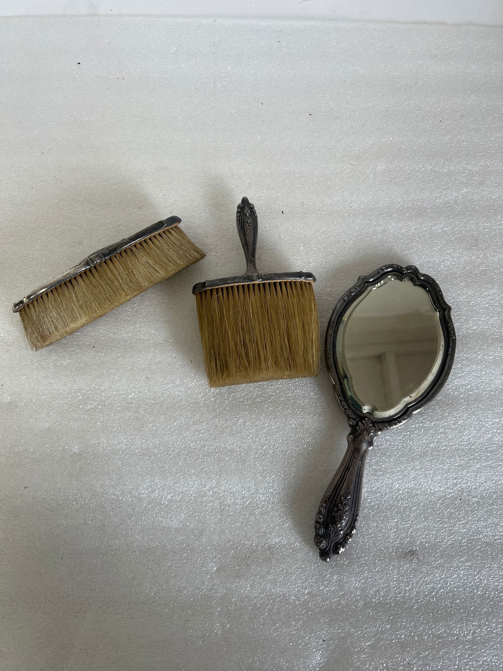 Tiffany & Co. Sterling Three Piece Dresser Set: Hand mirror and two brushes marked Tiffany & Co. Makers and Sterling. Three pieces in the lot.