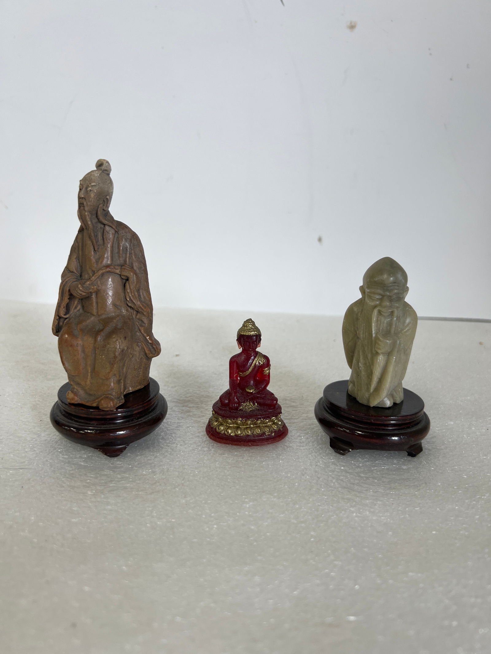 Antique Oriental Figures (3): Marble, pottery and glass. Two on teakwood stands.