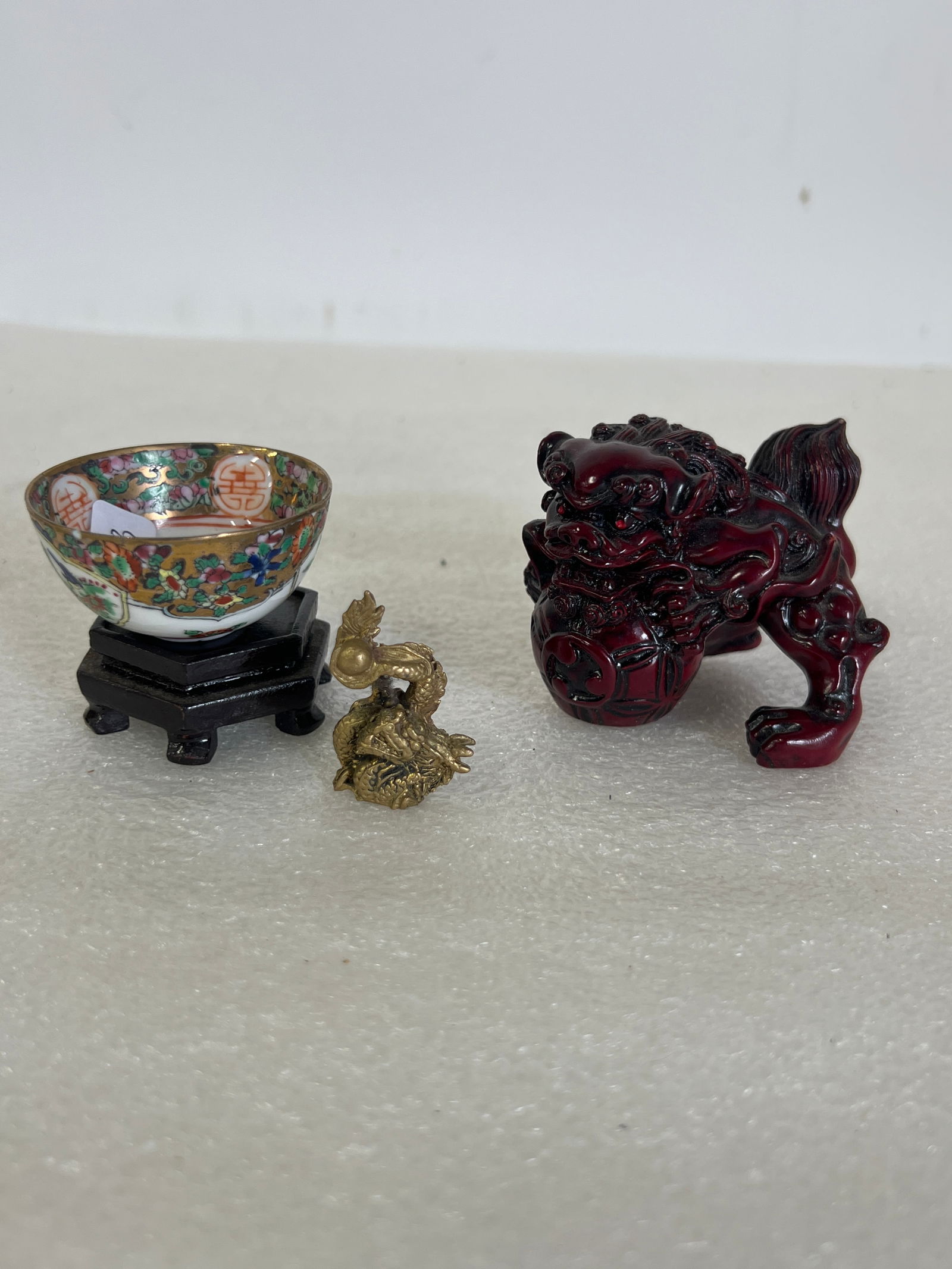 Oriental Antiques (3): Teakwood carving of a foo lion, miniature rose medallion bowl sgd. and brass figure sgd. 2.75”H to 1.5”H