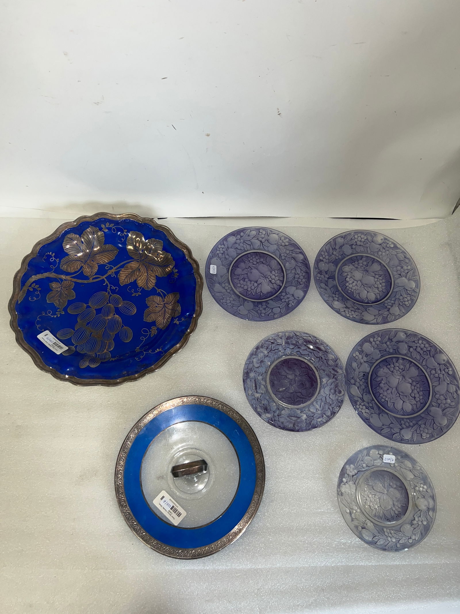 Collectible Lot of Blue Purple Glassware & Silver Decorated Platter (7): Handled compote with blue and silver rims; Rosenthal German porcelain platter silver overlay and five glass dishes 9 3/4" D (compote) 14" D. (platter) and dishes are 6 1/2" to 8 1/4"