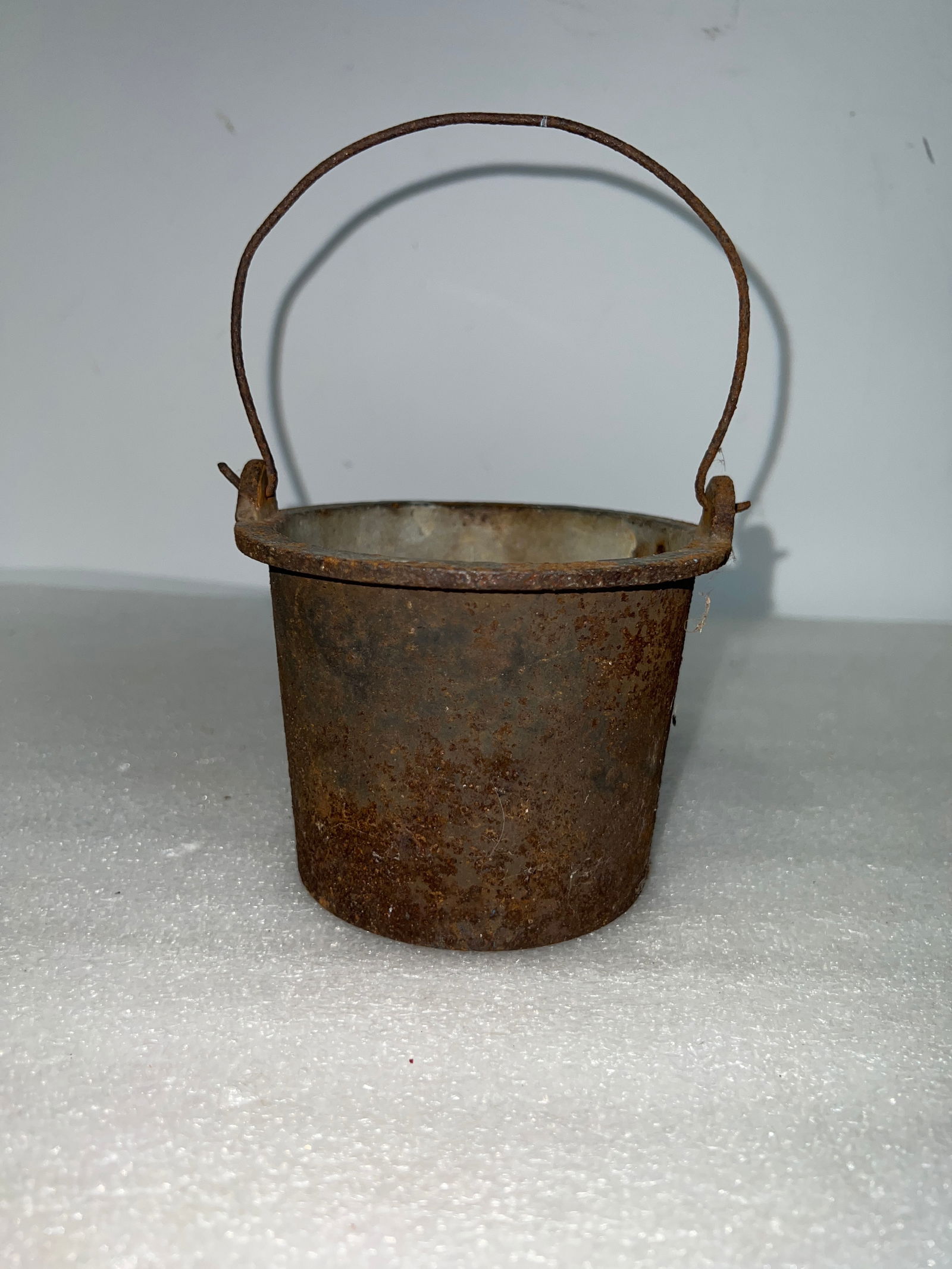Antique Cast Iron pot: With handle. 4"H 5"Wque.