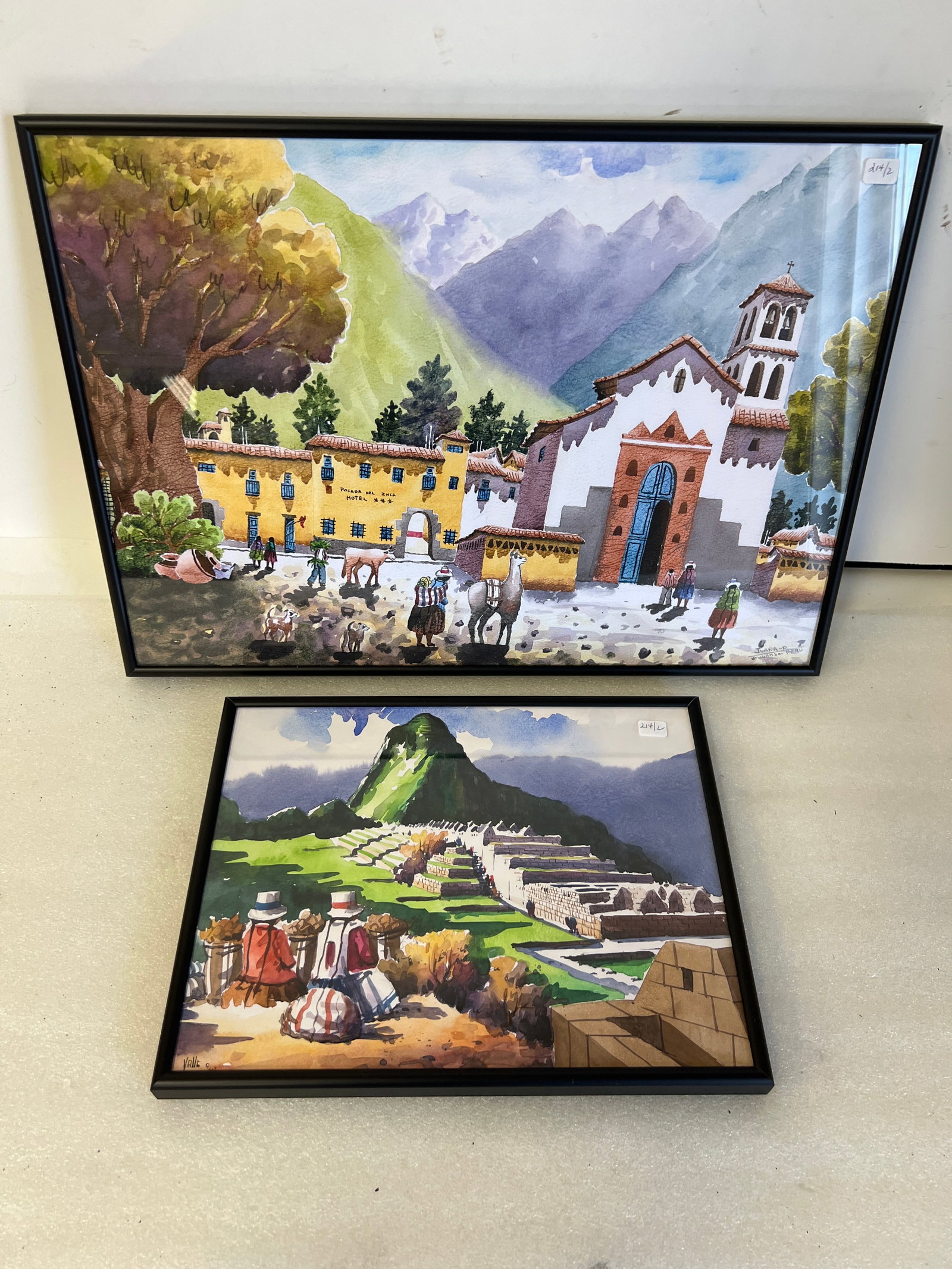 Peruvian Watercolors Street Scenes (2): Smaller one is 10”H by 13”W. Signed Valle lower left. The larger on is 14”H by 20”W. Signed lower right “Juana-P Urubamba- PERU”