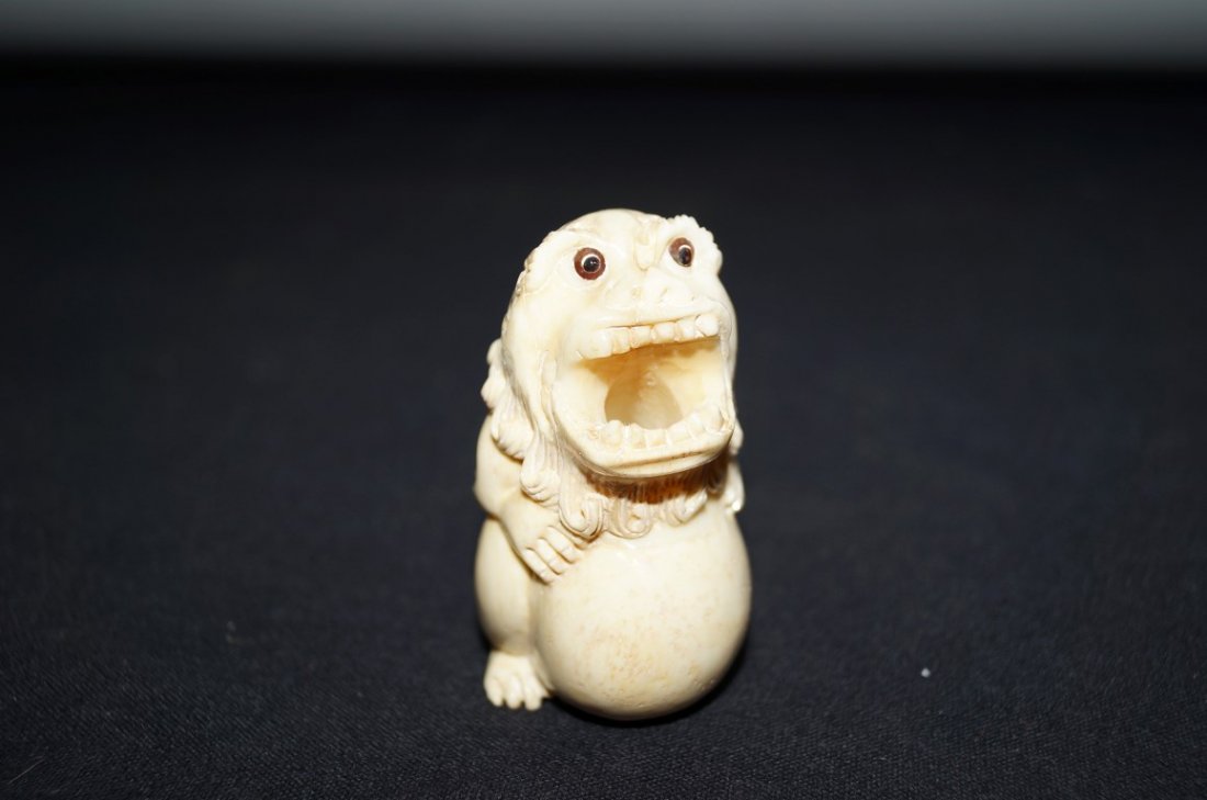Marine Ivory Foo Dog Pen Holder: Carved foo dog on ball pen holder; 2.5in. H.