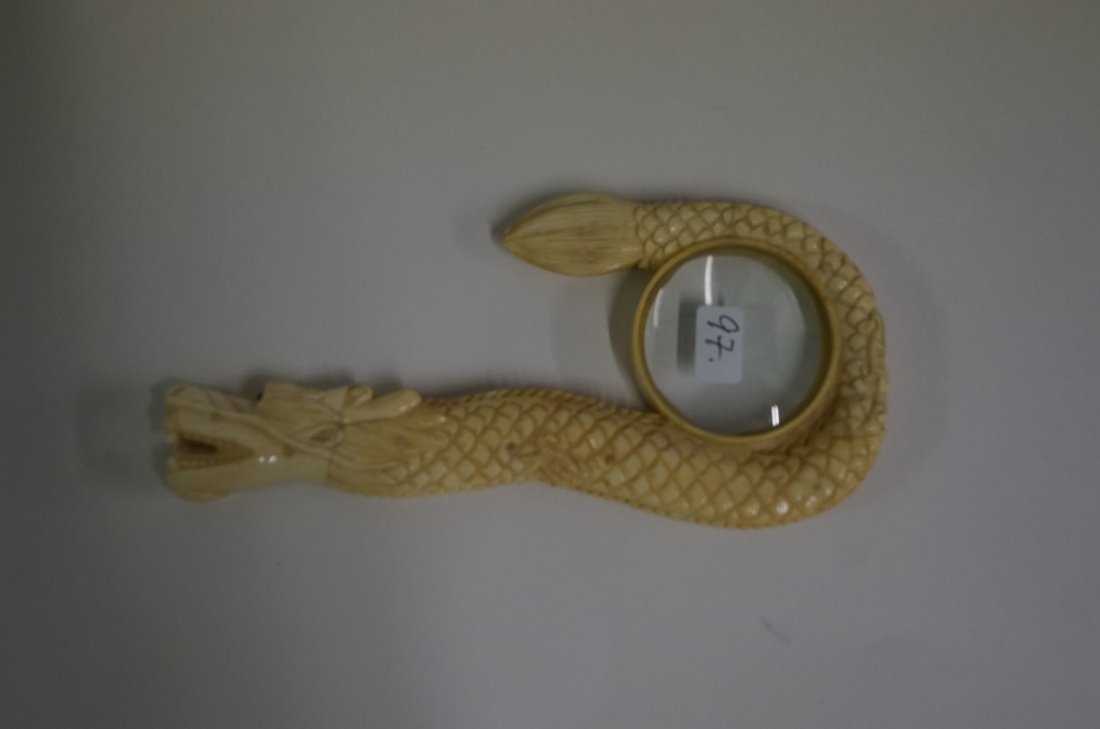 Marine Ivory Magnifying Glass: Carved magnifying glass. Dragon form; 5.75in. L.