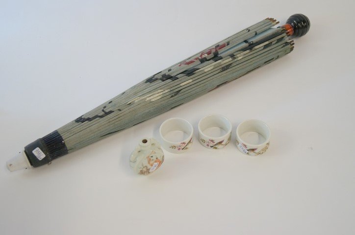 Lot of miscellaneous items: Three(3)painted porcelain napkin rings together with a snuff bottle (without top) and a painted paper parasol