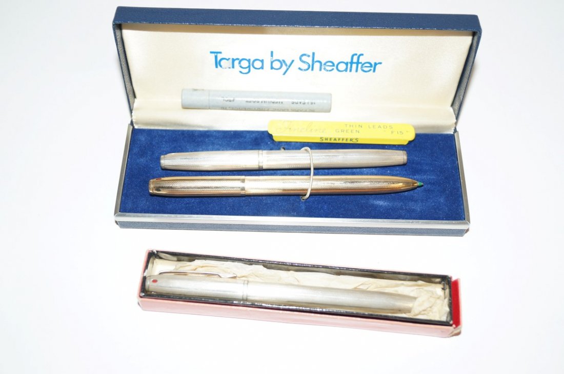 Three Dunhill Ball Point Pens: Two sterling silver cased. One gold cased
