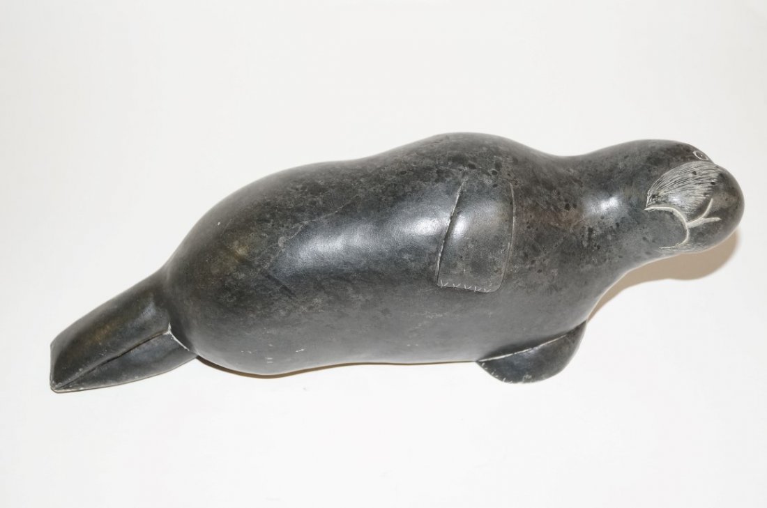 Inuit Eskimo carved Manatee: Carved stone figure of a manatee. Inscribed at underside; 3in. H. x 10.5in. L.