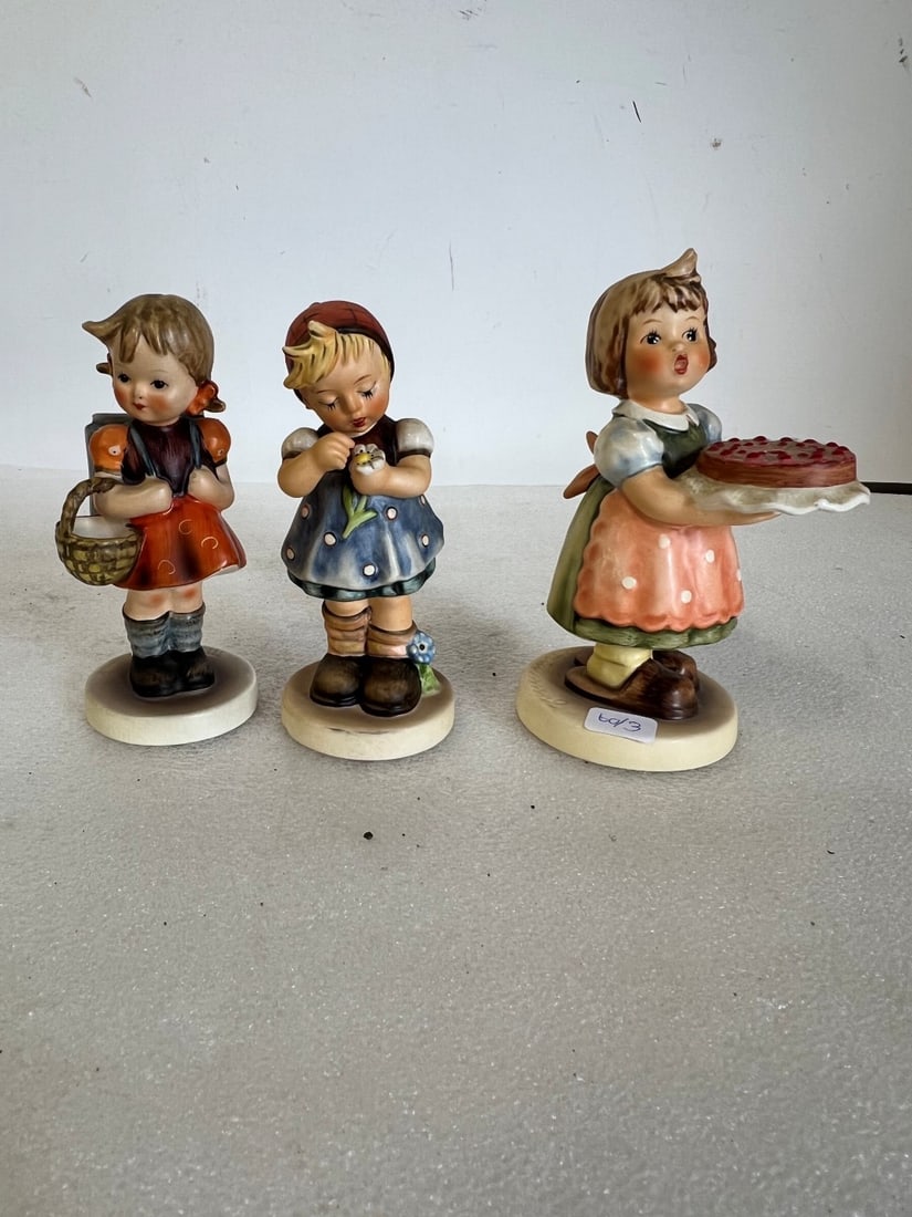 Hummel Figurines (3): All marked As pictured. Lot includes "School Girl", "Birthday Candle" and "Daisies Dont Tell". Tallest is 5.75"H and smallest is 5.5"H.