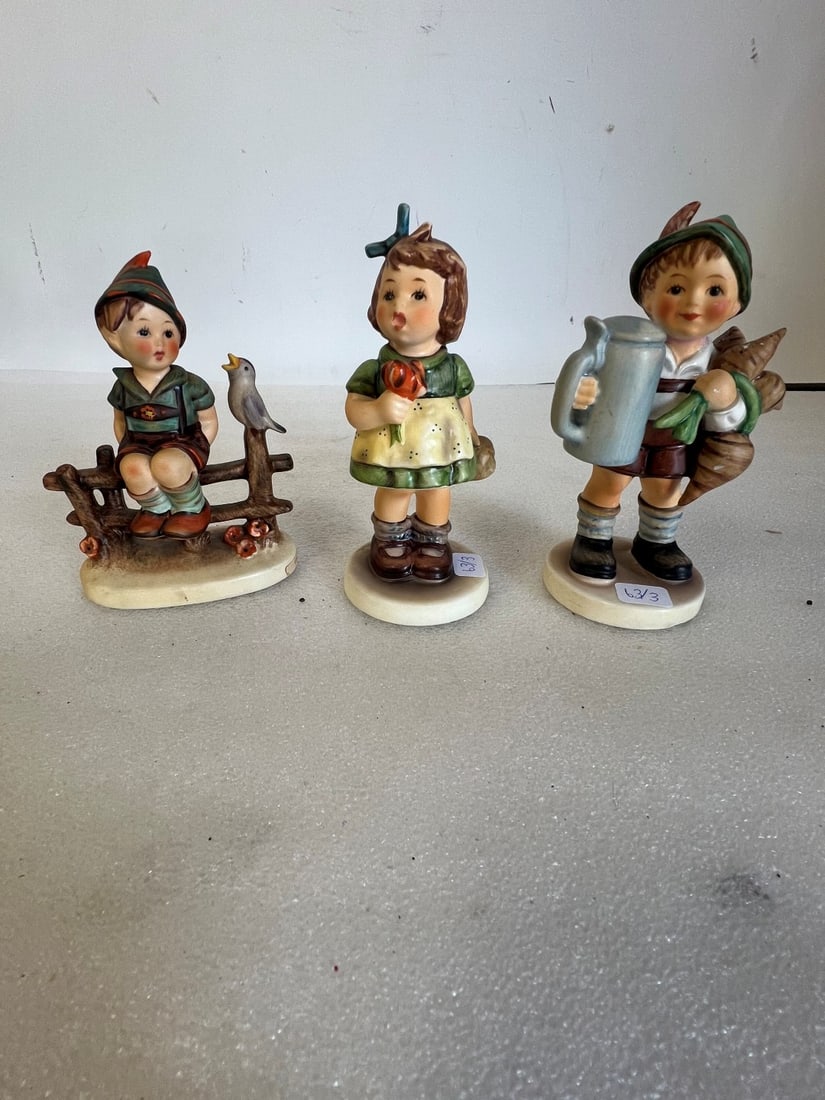 Hummel Figurines (3): All marked. As pictured. Lot includes "The surprise", "Wayside Harmony" and one other. Tallest is 5.75"H by 5.25"H.