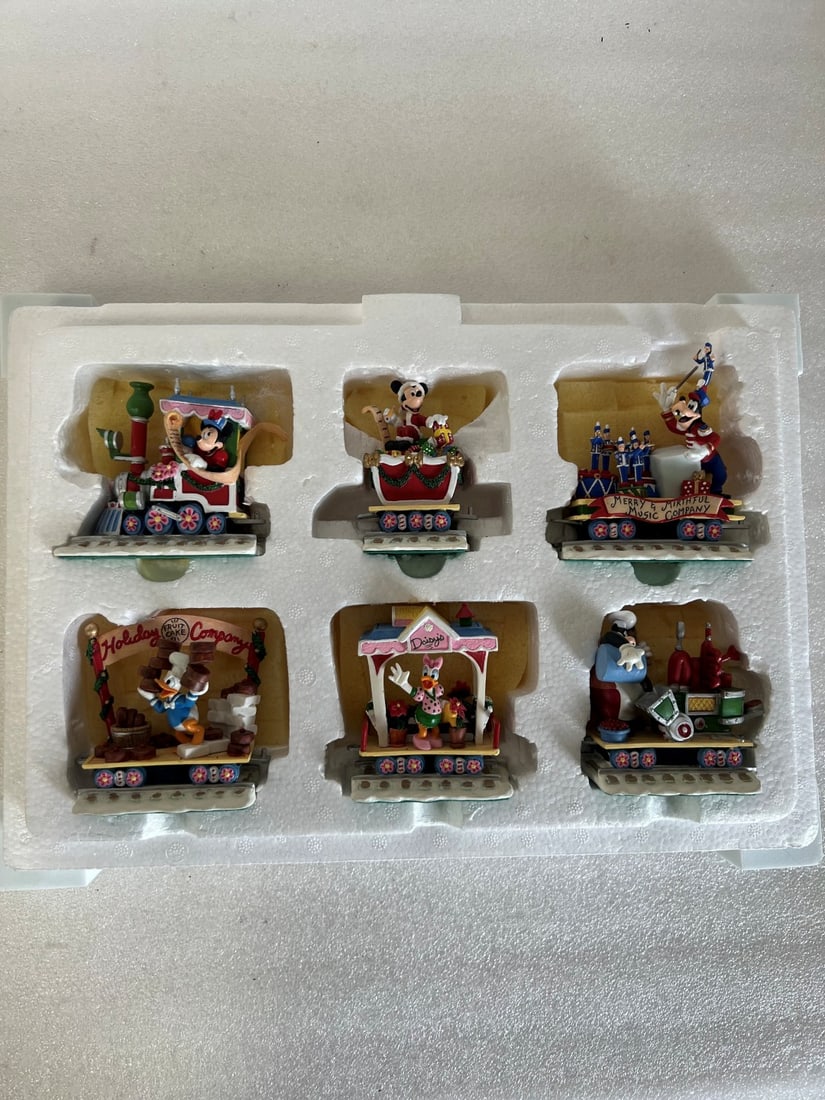 Danbury Mint Disney "Minnie's Merry Railway" Holiday Train Set.: 6 pieces in the lot. All are marked "Disney" at the underside. Tallest is 4.25"H and smallest is 3.75"H.