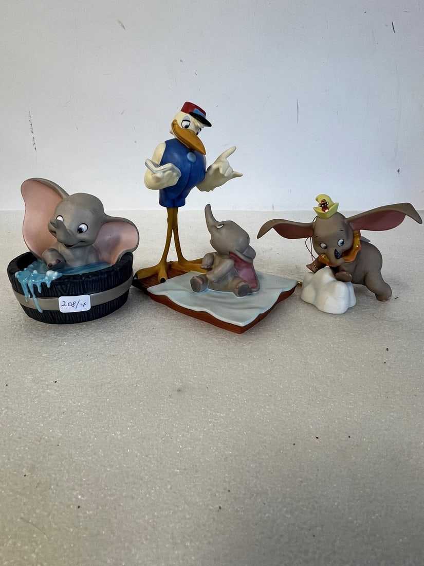 Lot of Collectible Dumbo Figures (4): Walt Disney Bundle of Joy Stork Grouping; Simply Adorable; and Orange collared ornament. Included in the lot is a white cloud like figure marked at the underside Disney and Dumbo and Timothy Mouse.