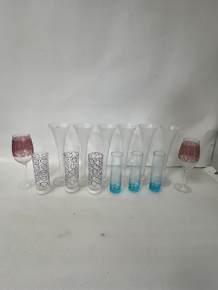 Lot of Antique Glassware (14): Six tall frosted and swirl glasses; three blue glasses; three art deco with circles and two stemmed ruby and clear. Fourteen in the lot