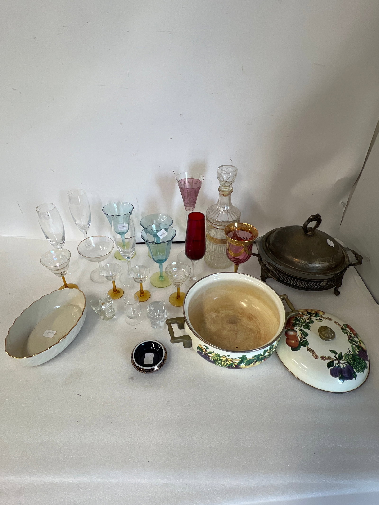Collectors Lot Of Glass and Collectables Inc. 22K Gold Limoges Bowl(22): Includes Ruby and Gilt decorated red glass; Blue Glass (3); Gilt decorated decanter, Lennox Bowl 22K Limoges Gold decorated (1”H by 3.25”W) marked at underside; etc..