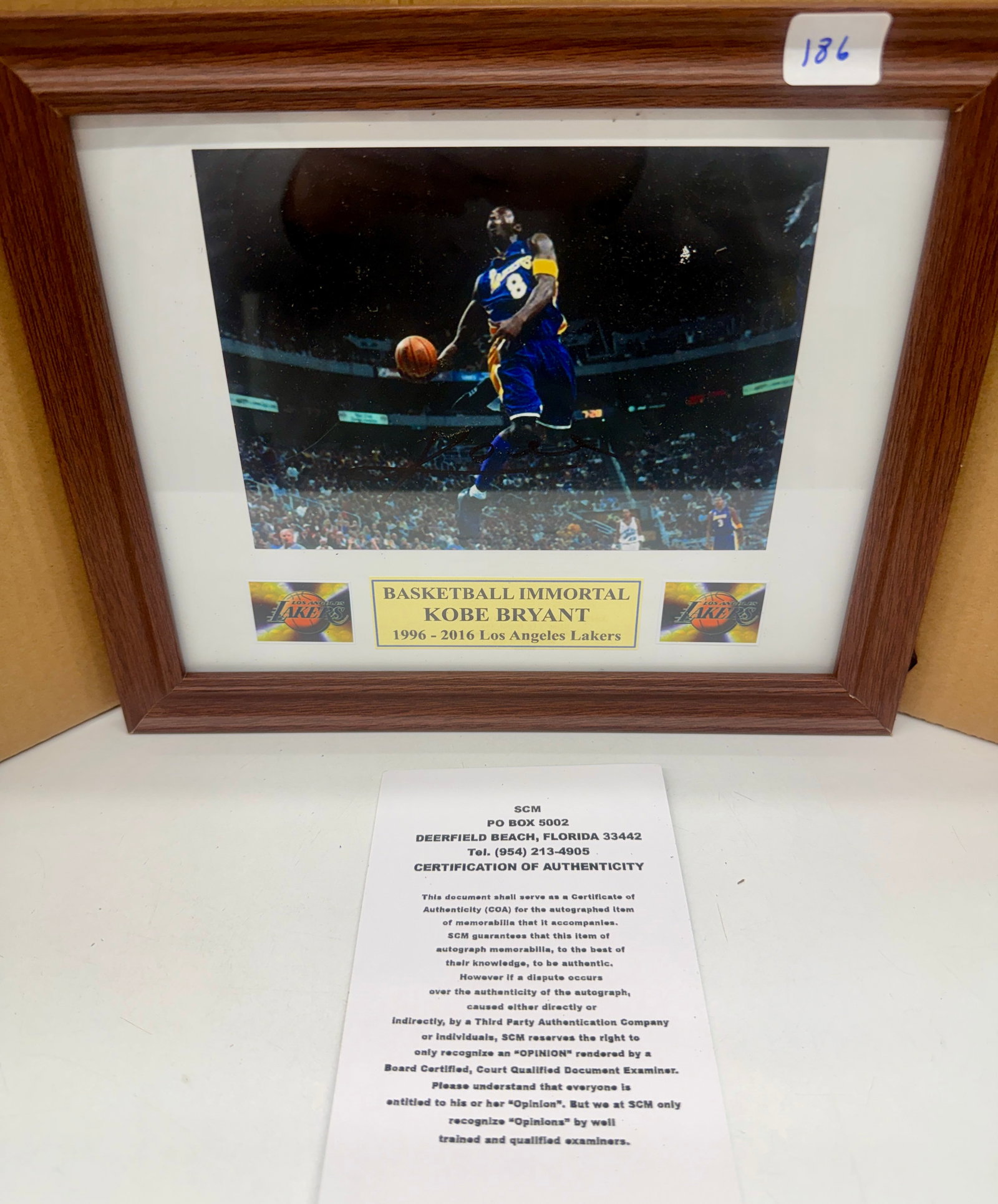 Kobe Bryant Signed Photograph with COA: “Basketball Immortal”. 8x10. With certificate of liability. Framed. Signed
