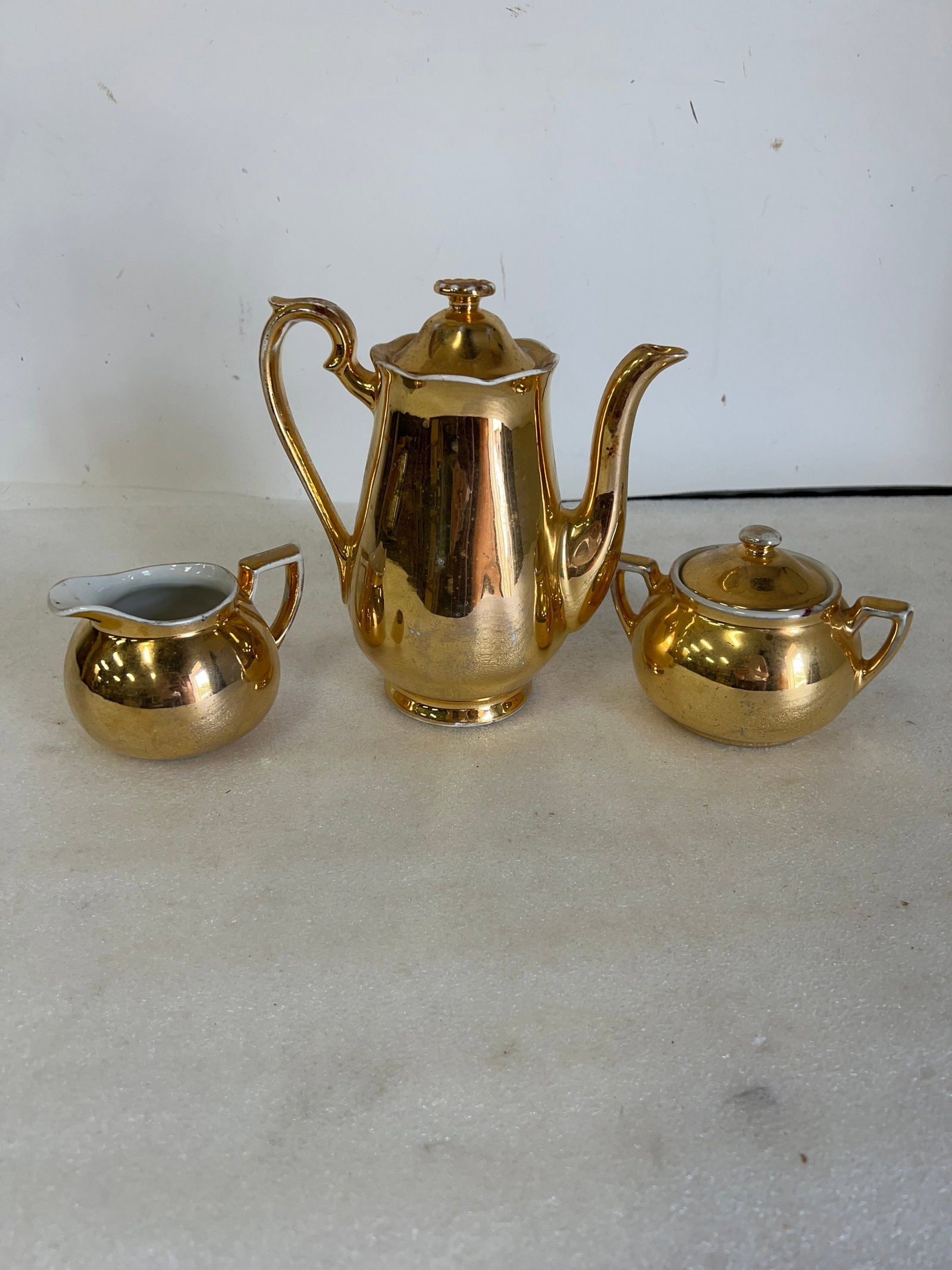 Golden Glo Set (3): Includes a Creamer, Sugar, and Coffee pot. On the Underside it says Golden Glo Hall, Warranted 22 Carat Gold