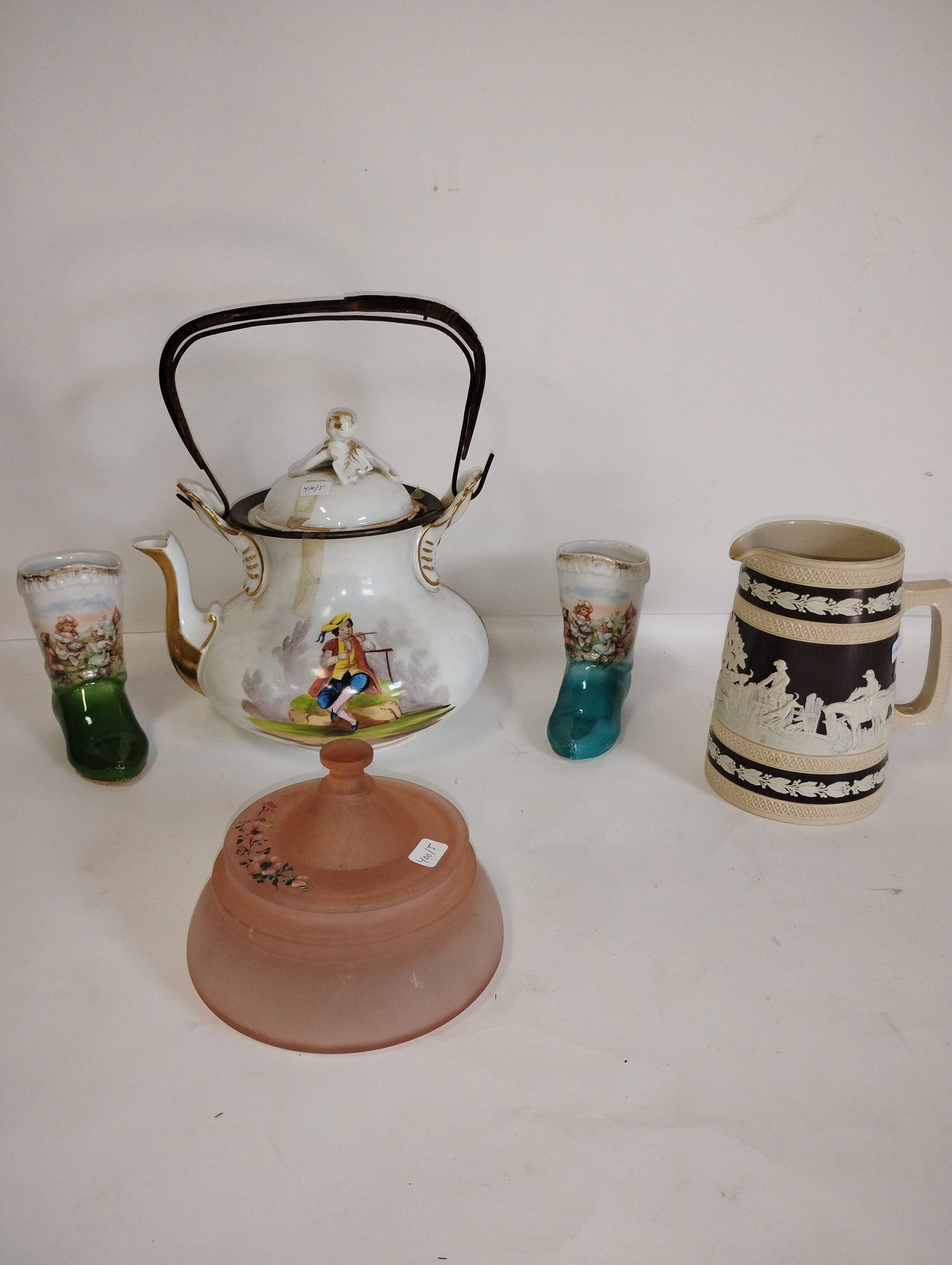A Collectors Lot of Antiques (5): A pink camphor glass covered jar, two porcelain boots decorated with children at play, a European Teapot, a Wedgwood like mug (minor chip at spout).