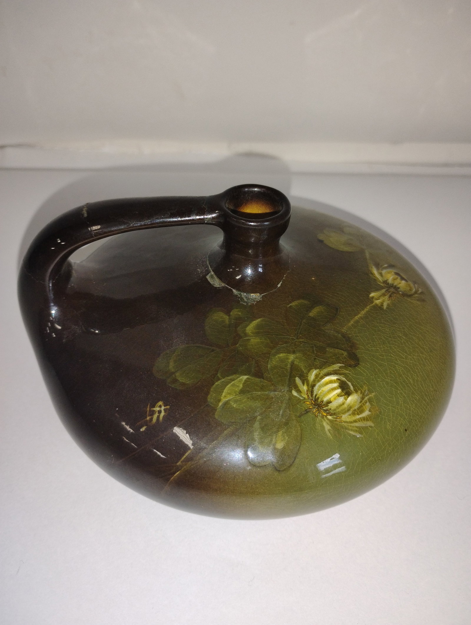 Louwelsa Weller Handled Jug Sgd: Louwelsa Weller floral decorated handled jig. Signed on the underside and numbered 519 5 1/2"W x 3"H