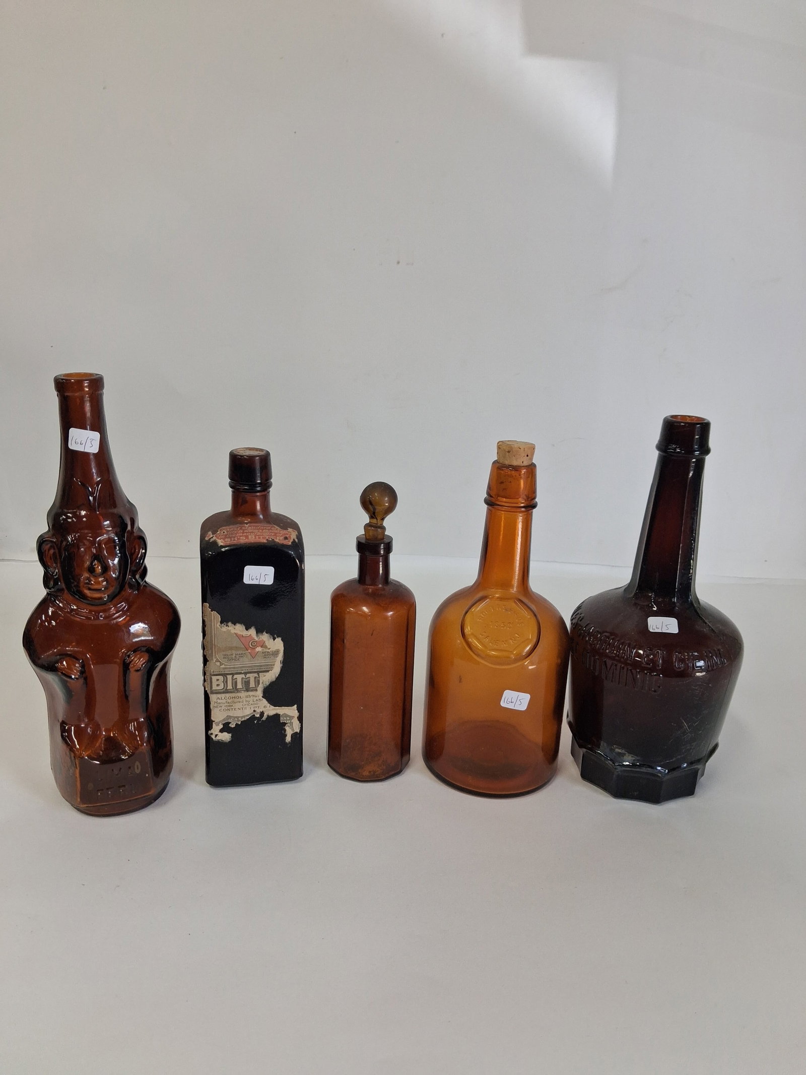 Collectors Lot of Assorted Bottles (5): Lot includes: Antique Cordial Bottle from Charles Jacquin Et Cie (11"H), ntique 1890s A.L. Murdock Liquid Food bottle from Boston, Mass., crafted from 12-sided embossed amber glass (9"), amber glass f