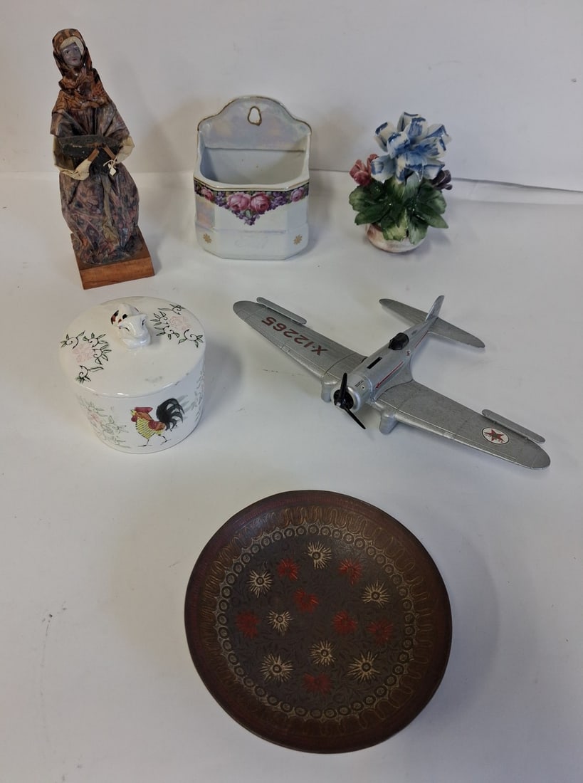 Dealer's Lot of Antiques (6): A figure, a rooster/cow covered jar, an open wall box, a floral sculpture, an Oriental bowl and a toy airplane bank missing one propellor Six items in the lot