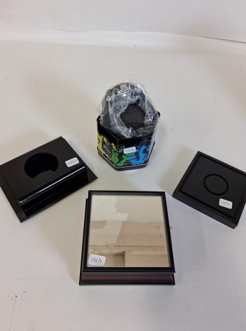Genoa Wristwatch New in Tin: New in Tin. As pictured, included in the lot are 3 good quality stands inc. one mahogany with a mirrored top 4 3/4in x 4 3/4in