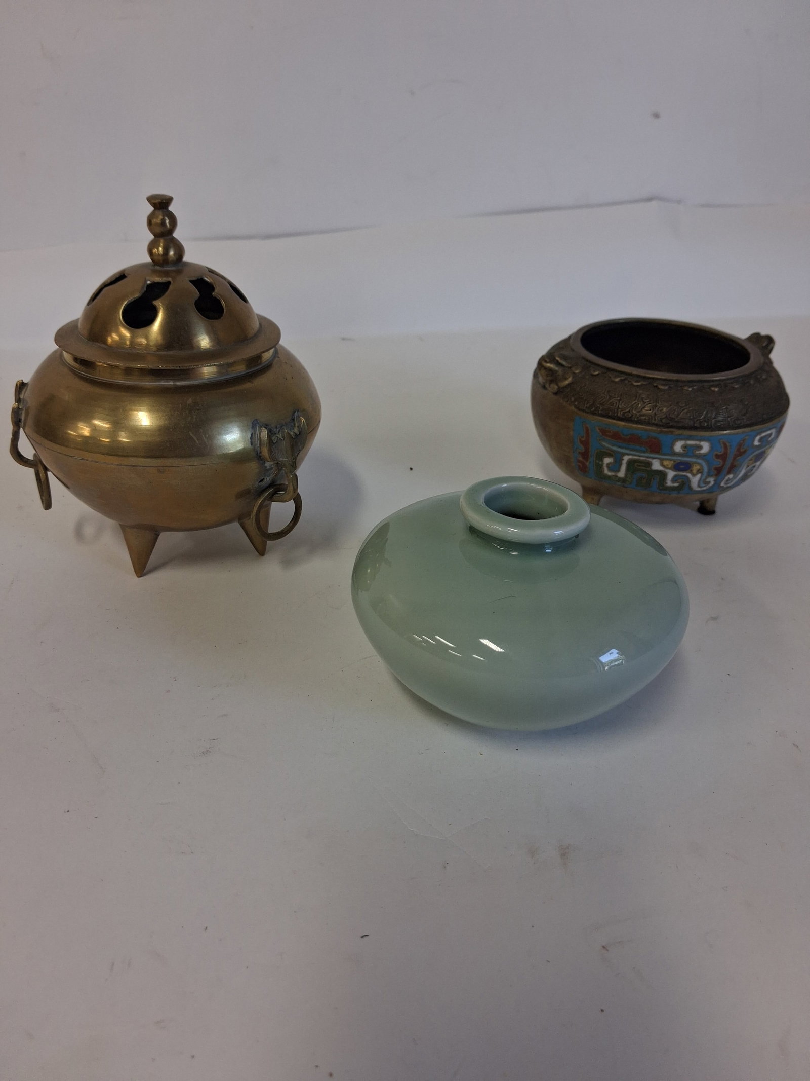 Quality Lot of Oriental Antiques (3): Footed bronze and cloisonne bowl 6in H; a brass incense burner 3 1 /8" H and a celadon vase Three items in the lot,