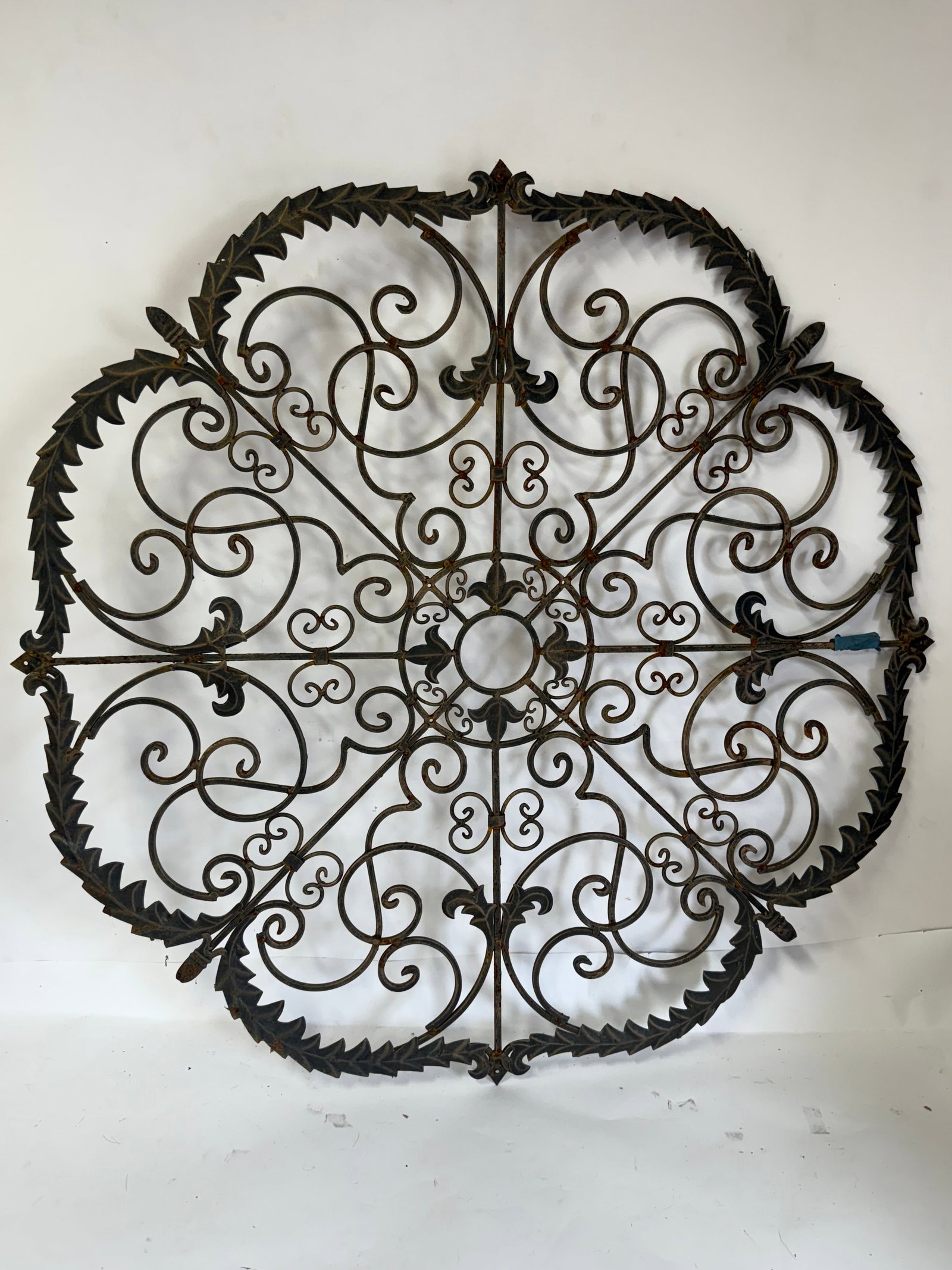 Large Gilt Iron Architectural Wall Decoration: Fancy gilt iron architectural wall decoration. Applied fleur de lis and leaf design; 38in. D.