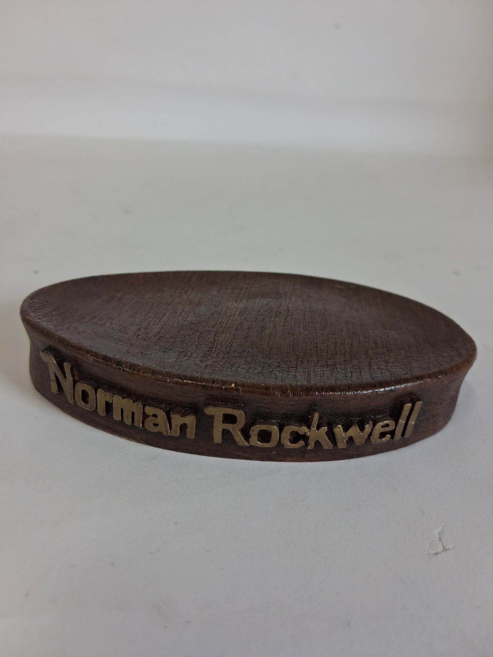 Norman Rockwell Stand for a Figure: Oval. Marked Norman Rockwell at the front in gold letters 6"L. 4"D