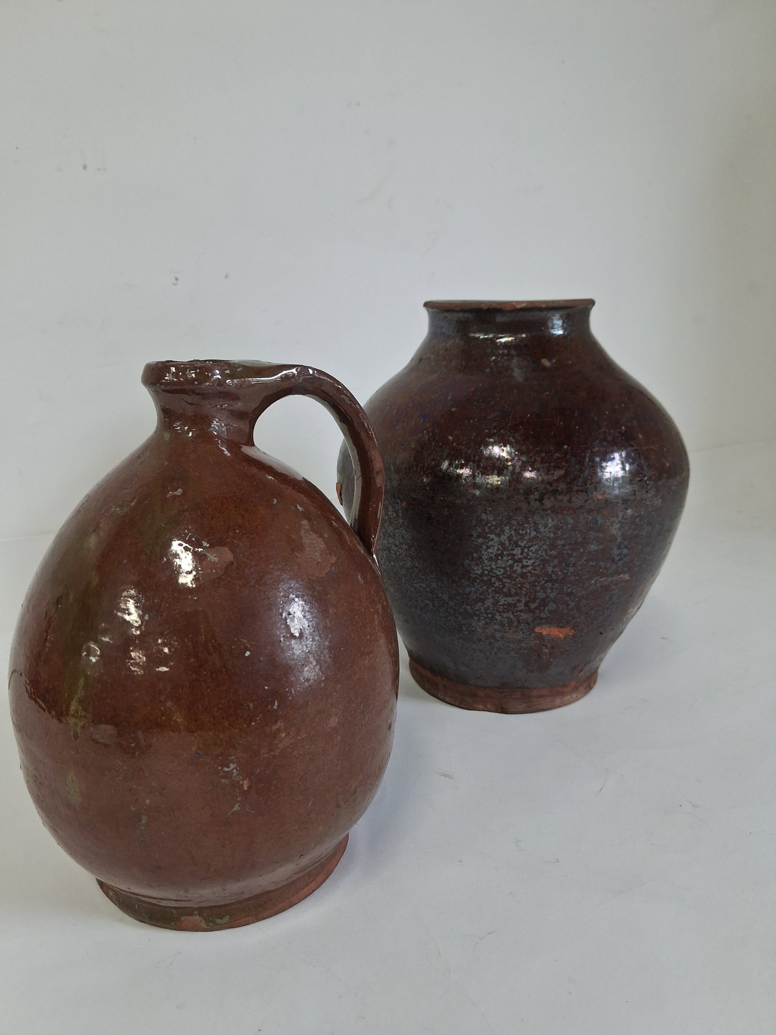 Brown Stoneware Jugs (2): 9 3/4" h x 8 1/2" w9in h with handle As pictured.