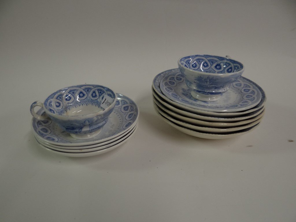 Staffordshire Blue & White China (12): Comprised of two cup; four shallow bowls; a small plate and five ironstone bowls. The ironstone bowls have classical scenes; the small plate and bowls have scenes of a girl child at play with an anima