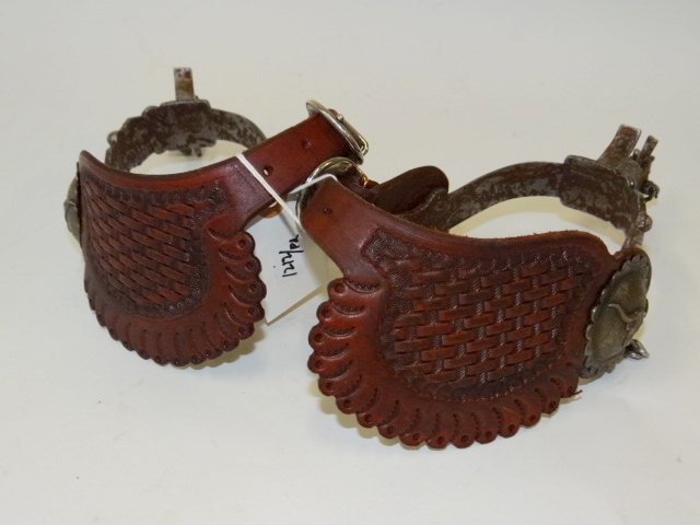 Pair of E. Garcia Western spurs: Pair of hand tooled leather and nickle plated spurs. Well decorated. Stamped E. Garcia; 9in. W.