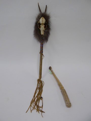 Lot of American Indian artifacts: Indian ceremonial rattle. Decorated with animal skull, antlers, and fur. Leather wrapped hadle with beadwork, 24in. H.; Braided leather crop, 17in. H.