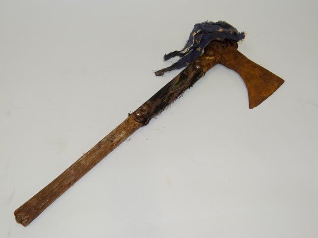 American Indian hatchet: Early hatchet with cloth wrapped handle and tack decoration. Top wrapped with flag fragment fringe; 19in. H.