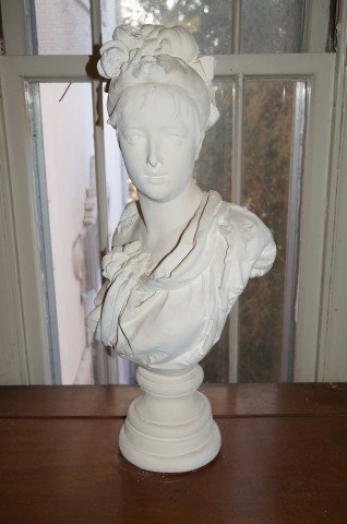 19th C. Bust Sgd. Carrier--Belleuse: Parian 19th c. French bust of a young woman with floral embossed and ribbon tied upswept hairdo impressed at the reverse A. Carrier Belleuse. 31"H.