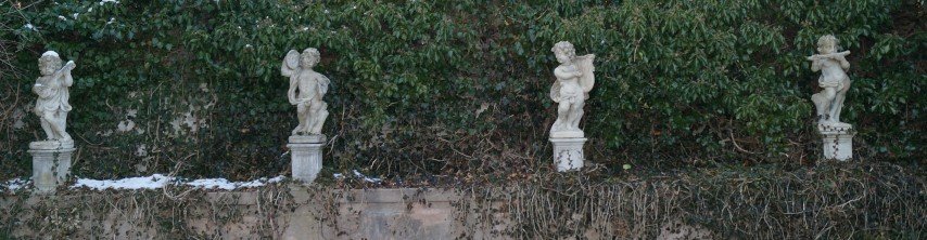 Statuary, Four Cherubs, The Seasons: Cast concrete. 46" with bases. PLEASE NOTE: IN HOUSE SHIPPING IS NOT AVAILABLE FOR THIS LOT. BUYER IS RESPONSIBLE FOR REMOVAL AND SHIPPING ARRANGEMENTS DUE TO WEIGHT AND SIZE.