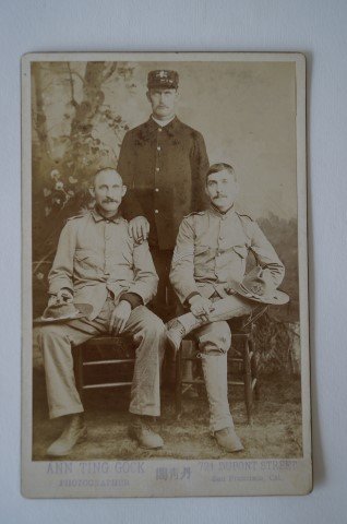 Cabinet Card. Three Soldiers.C. 1899: Clear cabinet card photograph of three soldier, Spanish-American War era by Chinese woman photographer, Ann Ting Gock, San Francisco. One seatd soldier has spats and sergeants stripes. Seated men have