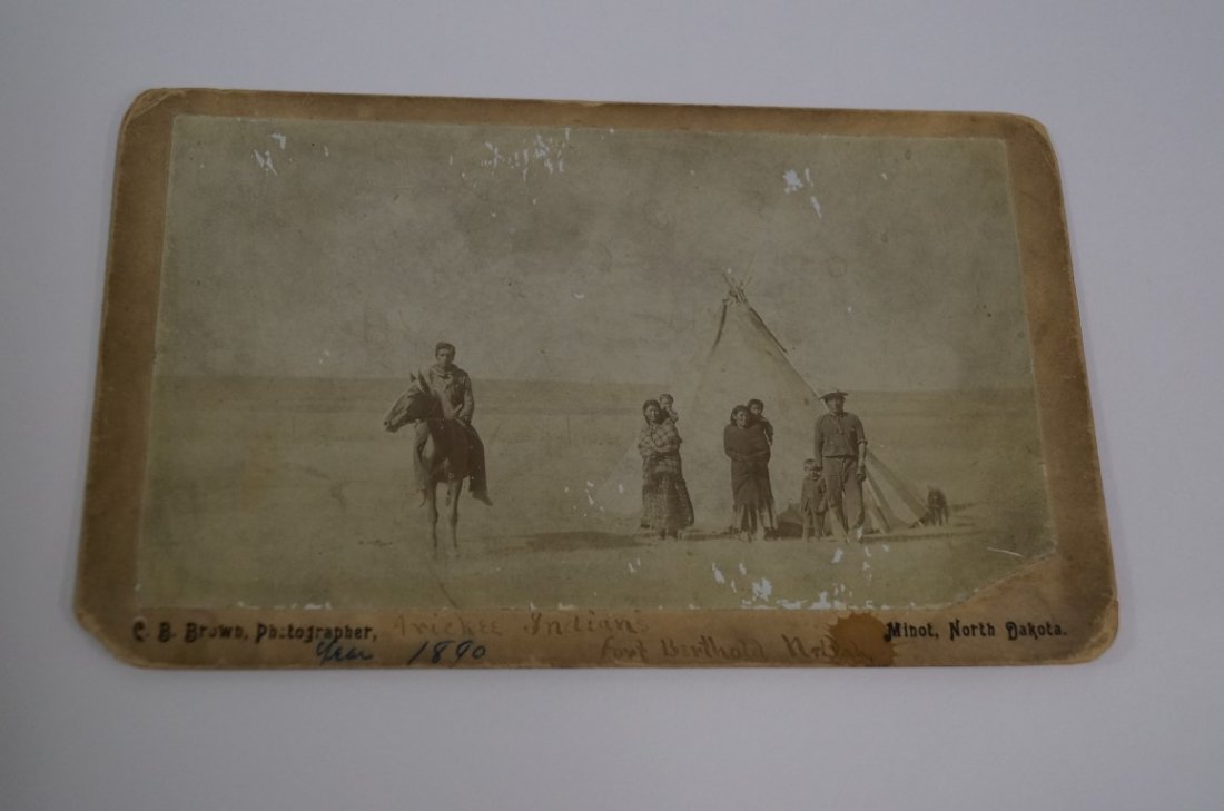 Arickaree Indians Dakota Photo: Albumen photograph of Indian family in front of teepee. One man mounted on Indian Â pony, another wears white man's clothes. Two squaws have papooses. Dog is in the photo. ID at back" Arickee(sic) I