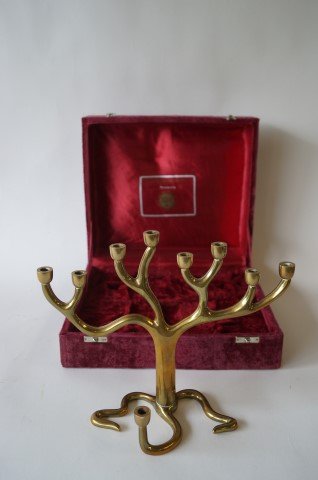 Rosenthal Judiaca Collection Brass Menorah by S Kravitz: Mid century modern brass menorah. Abstract form. Marked copyright Sandra Kravitz by Rosenthal. Paper label at underside. Fitted case; 9in. H. x 11in. W.