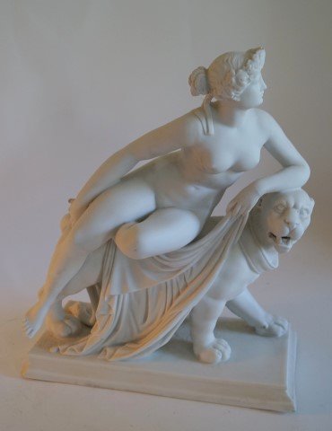 Antique Parian Porcelain Figure of Diana: Parian porcelain figure of Diana seated on a lion; 12.5in. H. x 10.5in. W.(as is with chips at the base)