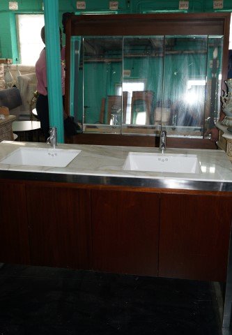Mid Century Design Custom Basins: Double face basins by Kohler in a marble topped counter. Faucets by Crom. Stainless Steel and Chrome fittings. With custom made beveled mirror cabinets with shelved interiors. 34"H. x 61"W. x 21"D (ba