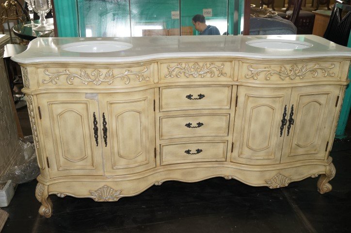 Marble Topped French Provincial Basins: Custom designed exceptional French Provincial basin cabinet featuring three drawers, four doorshaving shelved interiors with oval double sinks in the marble top. Raised on cabriole legs. 37"H. x 71"W.