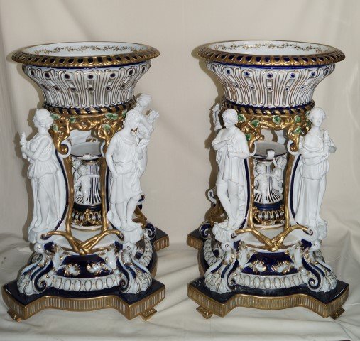Pr. European Porcelain Centerpieces: Spectacular centerpieces. Hand painted. The Four Seasons classical figures support the reticulated cachepots at the top. Blue crossed sword mark under the glaze. . 28". X 16"W. x 16"D.