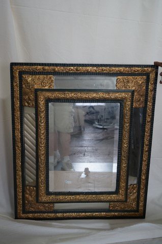 19th C. Brass Repoussed Mirror: 19th C. paneled brass and beveled glass mirror. Heavy weight. Original antique wooden frame33"H. x 28"W