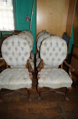 Victorian Dining Chairs (6): Two arm chairs and four side chairs. Tufted upholstered seats and backs Well carved wood frames. Brass handles at the top Thse chairs were the prototype for chairs created . By Ralph Lauren for his fu