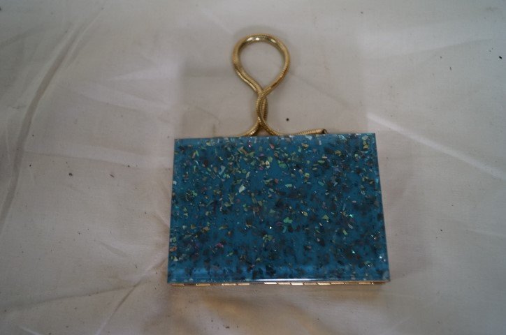 1950's Evening/Make-Up Case: Flecked "jeweled" surface. "Gold" handle. Fitted interior with lipstick, powder case, cigarette section and mirror. 3 1/2"H. x 4 1/2"W.