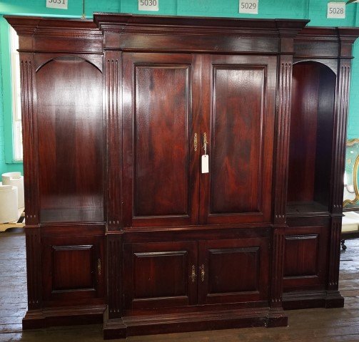 Three(3) Section Mahogany Wall Unit: Central double door cabinet. Lower section with double doors. Flanked by two(2) open arched bookcases. Single doored; 84in H. x 93in. W. X 29in. D. (central section - 84in.H. x 55in. W. x 29in.